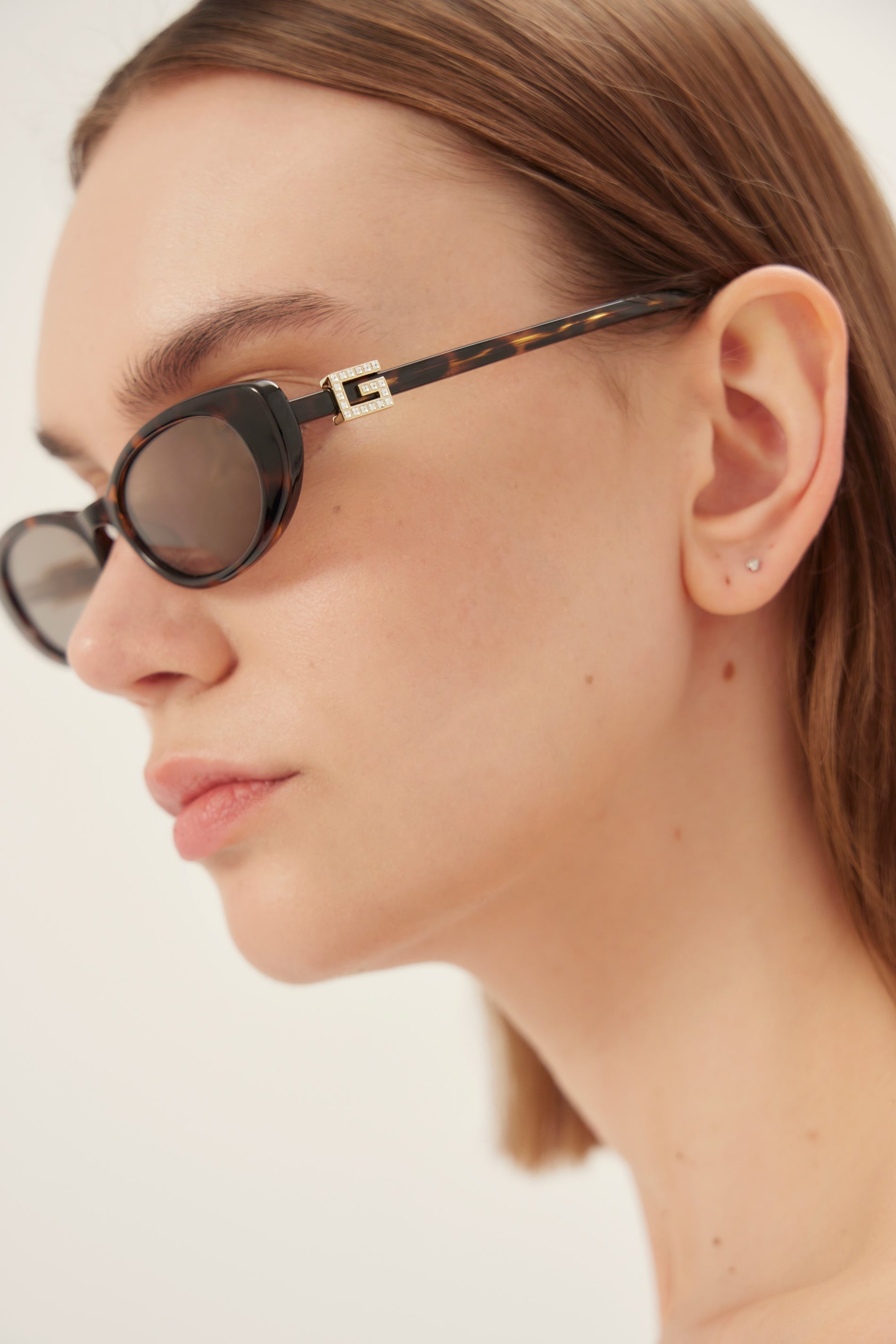 Oval cat-eye brown and grey Gucci sunglasses with gold logo